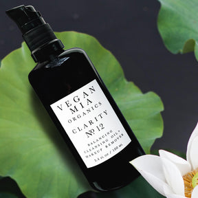 Vegan Mia Organics Clarity Balancing Cleansing Oil and Makeup Remover Bottle on Lily Pad with White Lotus Flower